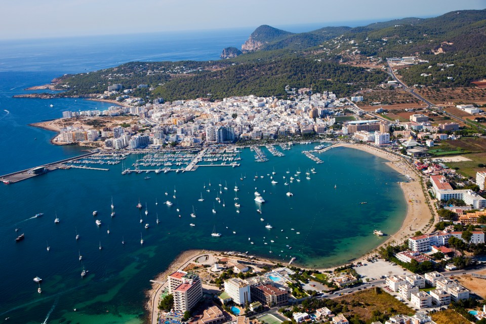 Aerial view of Sant Antoni de Portmany, Ibiza, showing the harbor and Playa de San Antonio.