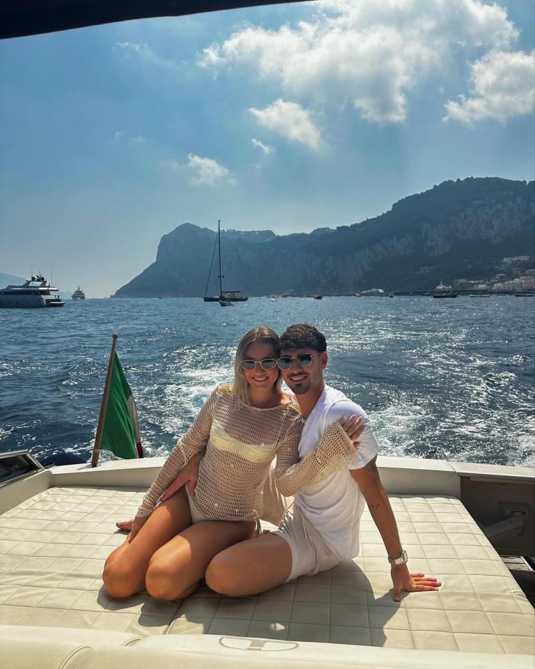Couple sitting on a boat in Italy.