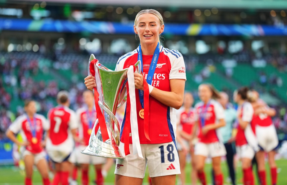 Chloe Kelly of Arsenal holding the UEFA Women's Champions League trophy.