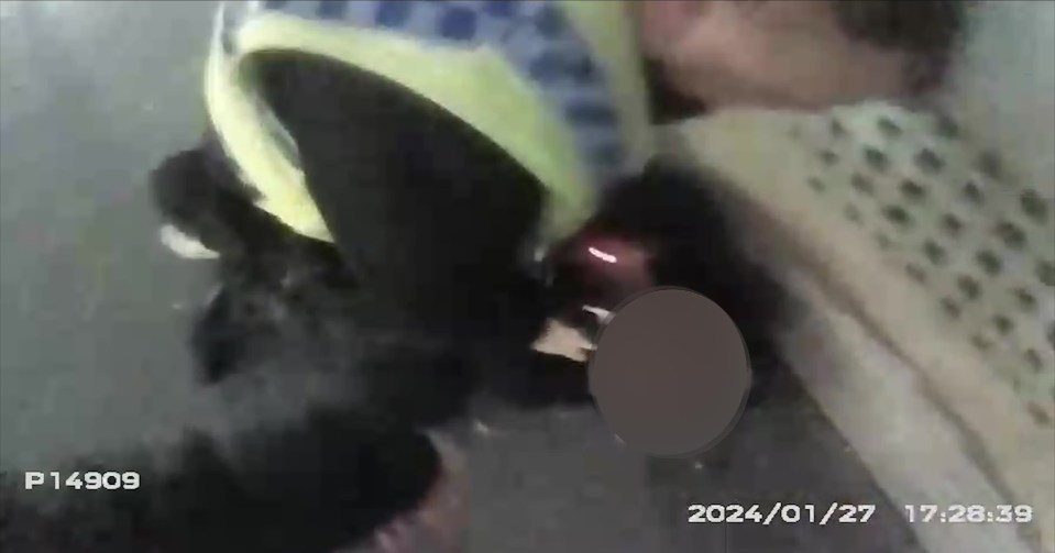 Video still of a police officer making an arrest.