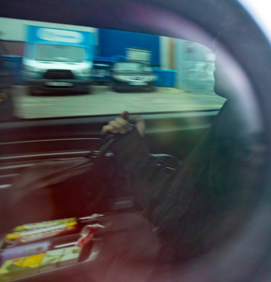 Blurry photo of Noel Gallagher in a car.
