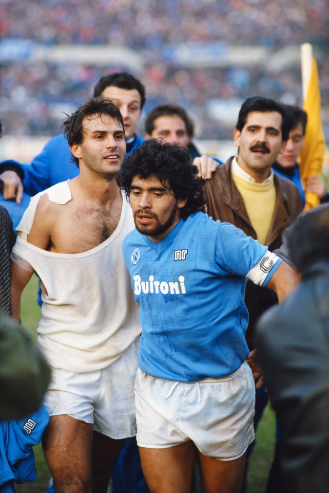 TURIN, ITALY - MARCH 09: Napoli captain Diego Maradona (r) leaves the field with Juventus player Antonio Cabrini after the Serie A match between the sides on March 9, 1986 in Turin, Italy. (Photo by David Cannon/Allsport/Getty Images)