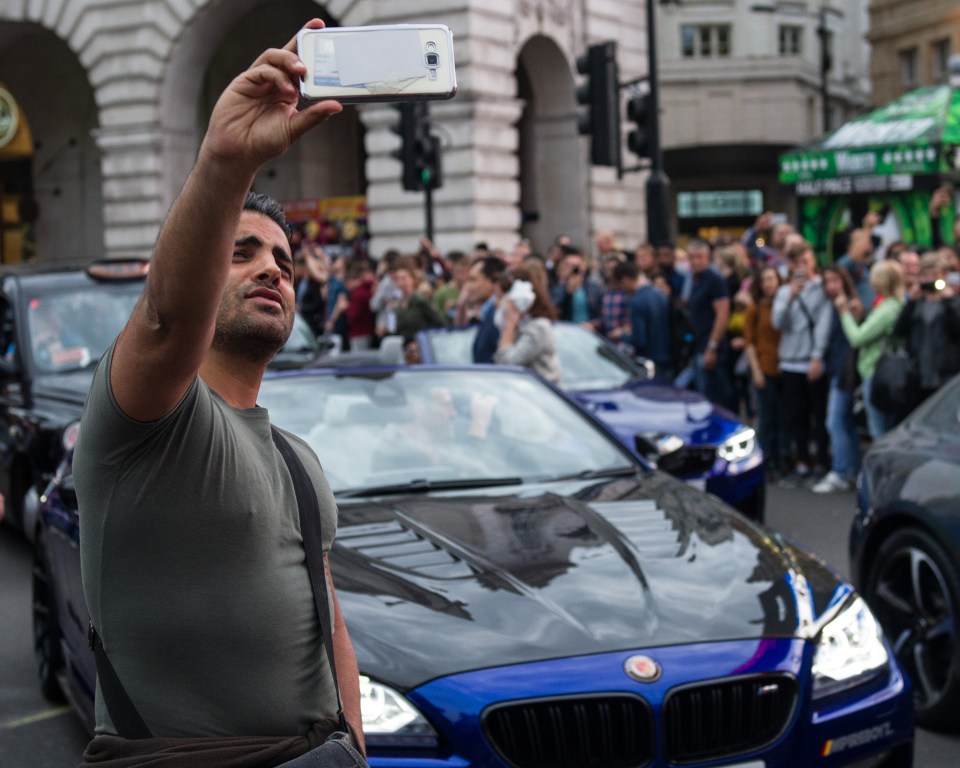 Hundreds of tourists rushed to have pictures taken with the luxury cars on Saturday