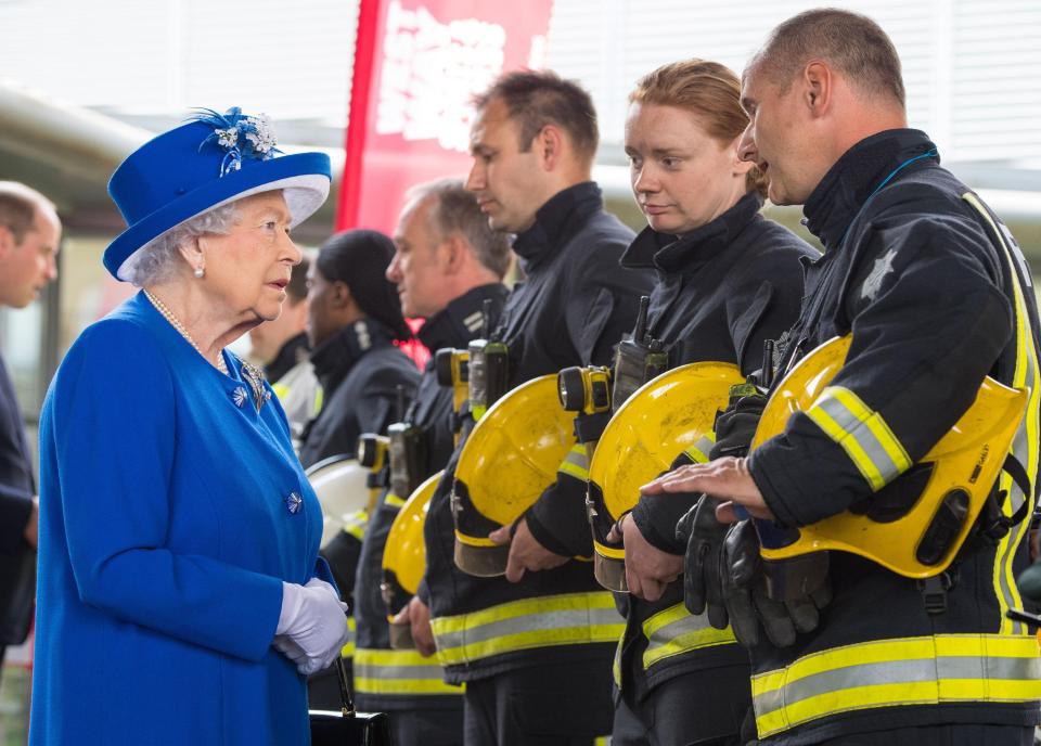 Queen Elizabeth II meets firefighters during a visit to the Westway Sports Centre, London, after the fire to thank them for their heroics