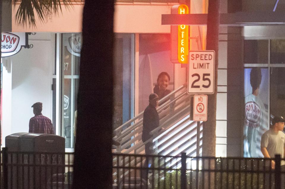  The 33-year-old was then seen using an ATM outside Hooters - a bar famed for scantily-clad waitresses