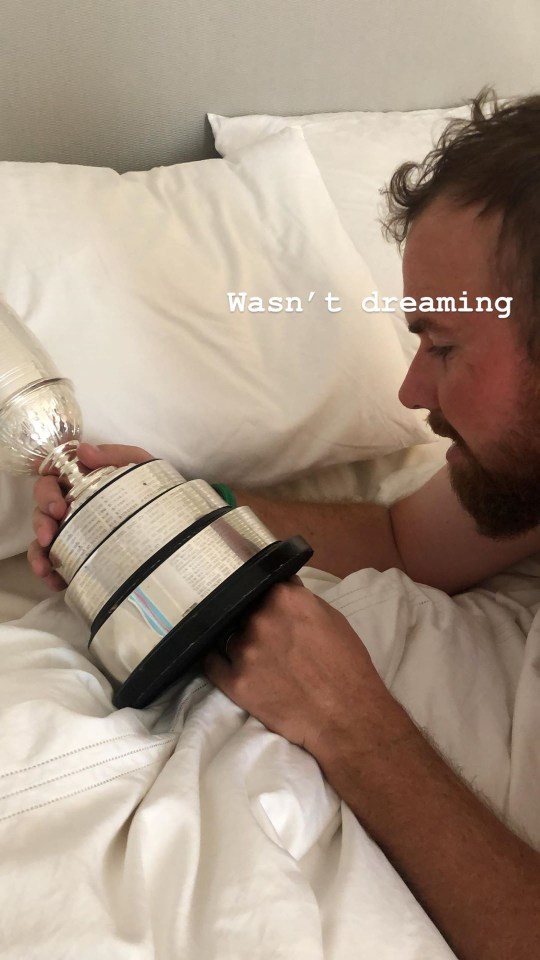  Lowry stares at the Claret Jug as his wife posts an image of him with the trophy