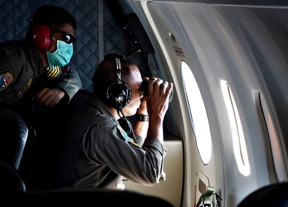 Crew members of Indonesian Navy's maritime patrol search for the submarine