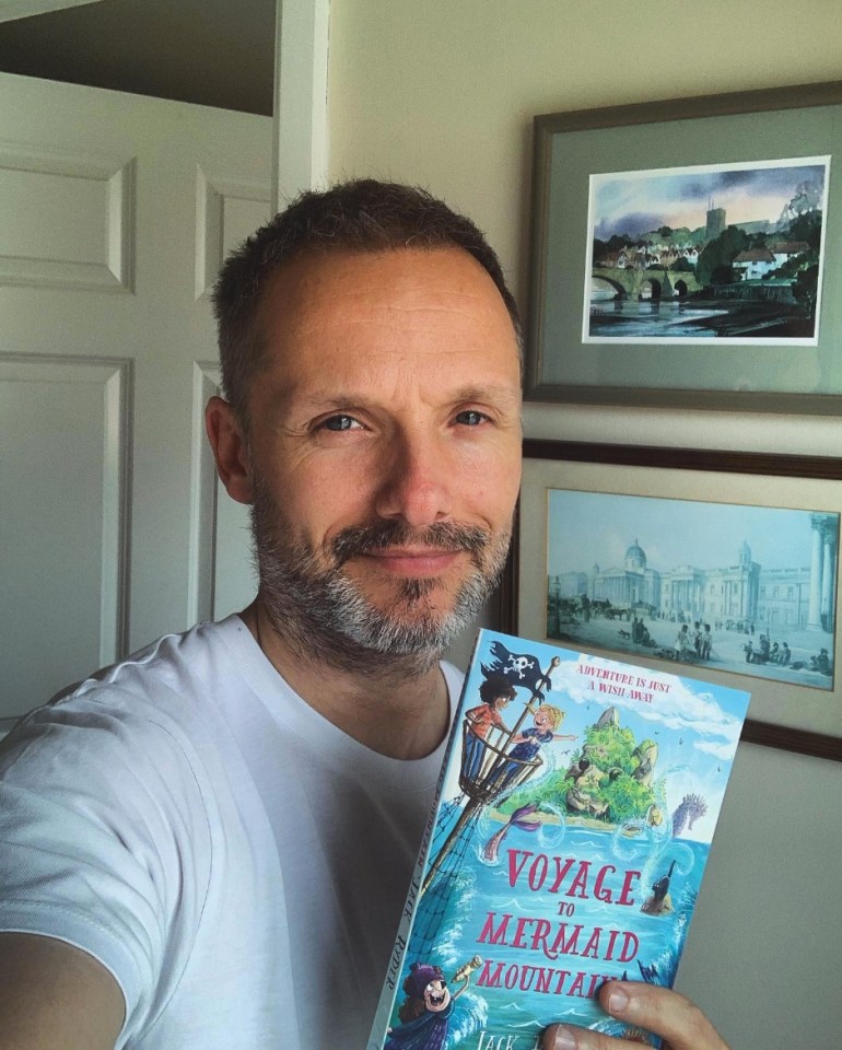 Jack Ryder holding his book, Voyage to Mermaid Mountain.