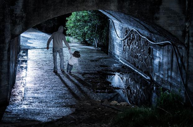 Man abducting a child at night.