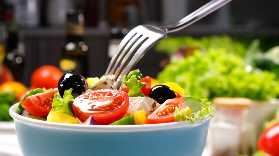 a salad in a bowl with a fork in it