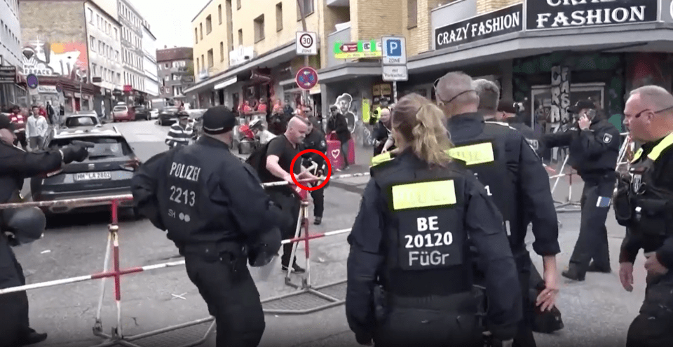 A crazed axeman is seen threatening officers in Hamburg near a Euro fan zone full of Dutch supporters