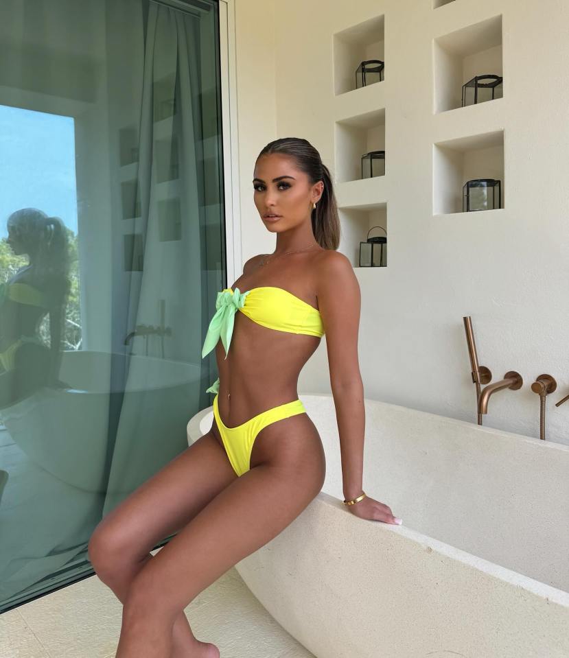 a woman in a yellow bikini sits on a bathtub