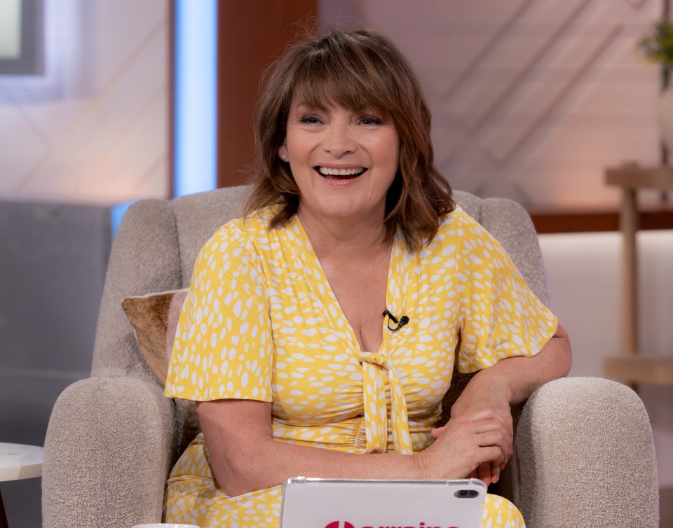 a woman in a yellow dress is smiling while sitting in a chair