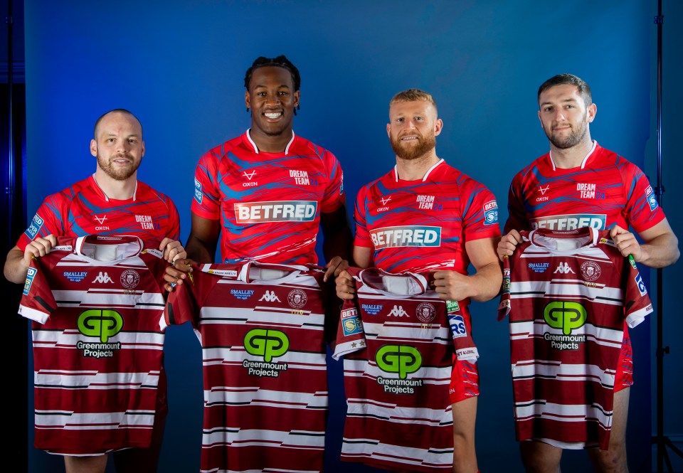 a group of rugby players holding up jerseys that say betfred