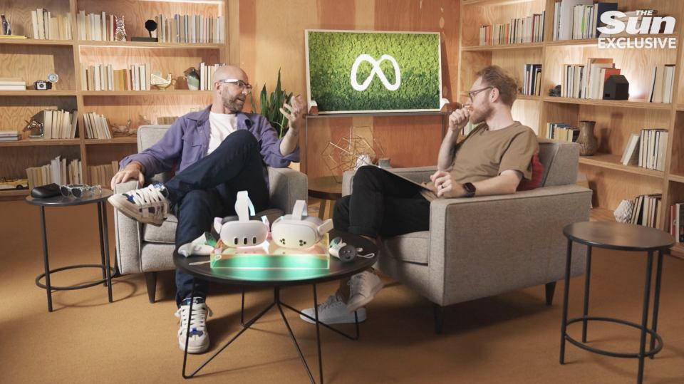 two men sit in chairs in front of a screen that says the sun exclusive