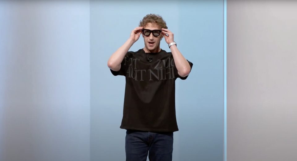 a man wearing glasses and a black t-shirt that says " zl " on it