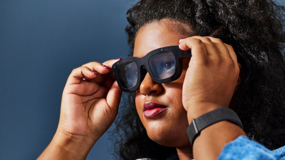 a woman wearing sunglasses and a smart watch