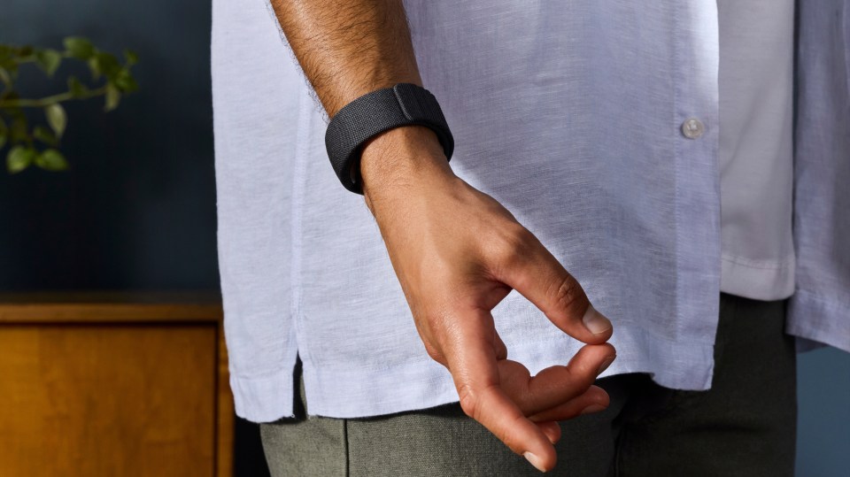 a man wearing a white shirt and a black watch on his wrist
