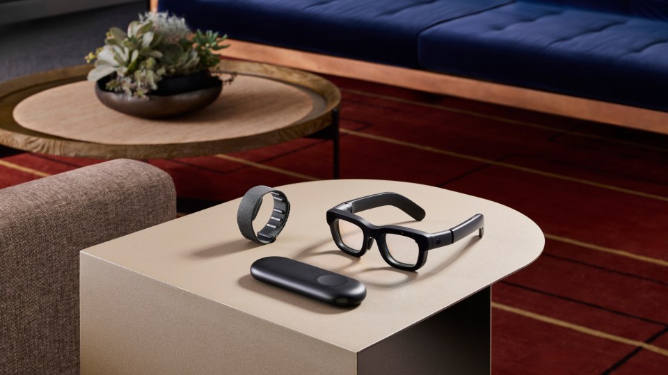 a pair of glasses and a smart watch are on a table