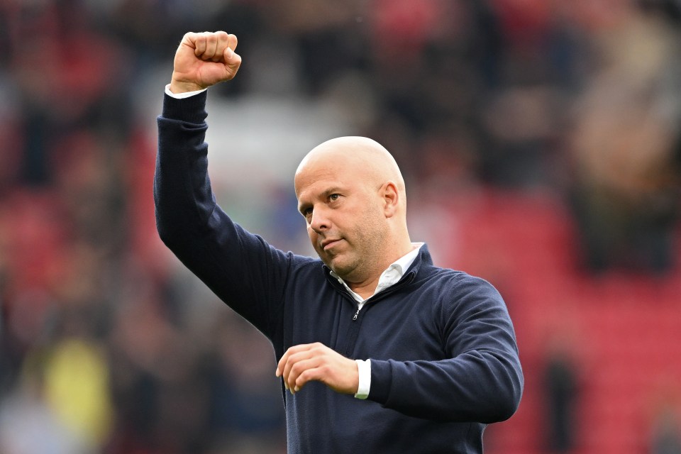 a bald man with his fist in the air