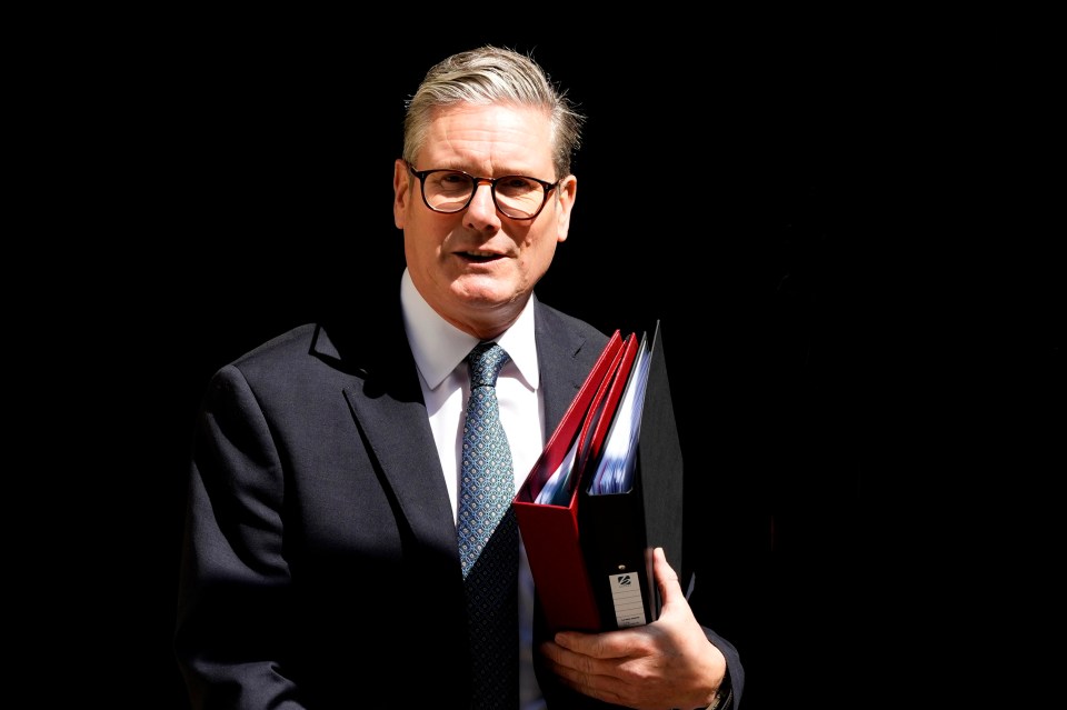 a man in a suit and tie is holding a folder that says ' a ' on it