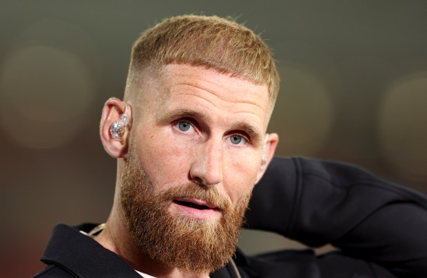 a man with a beard and ear buds on his ears