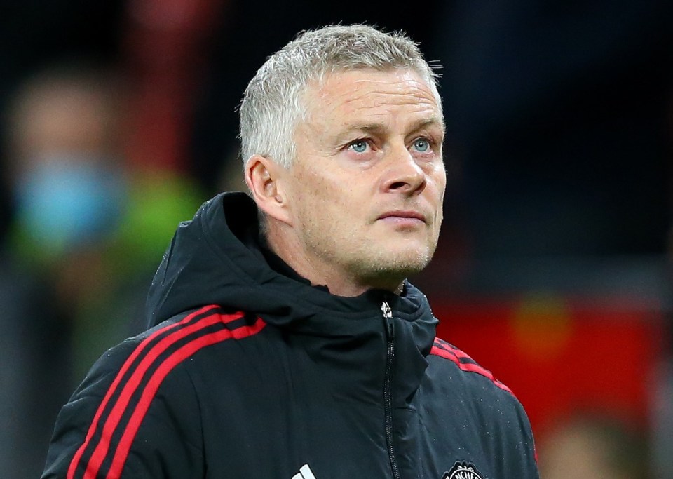 a man wearing a black jacket with the word adidas on it