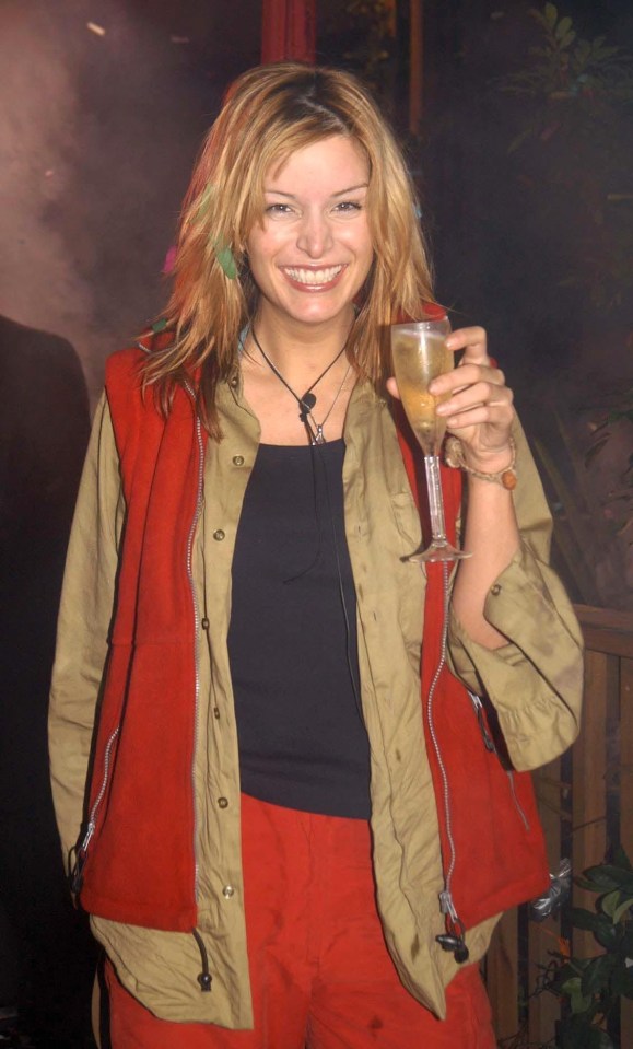 a woman in a red vest is holding a glass of wine