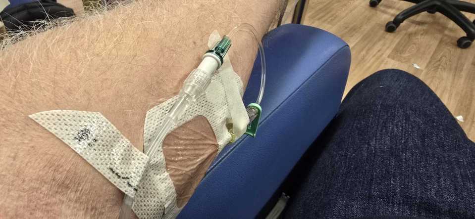 a person with a needle in their arm and a bandage that says ' j ' on it