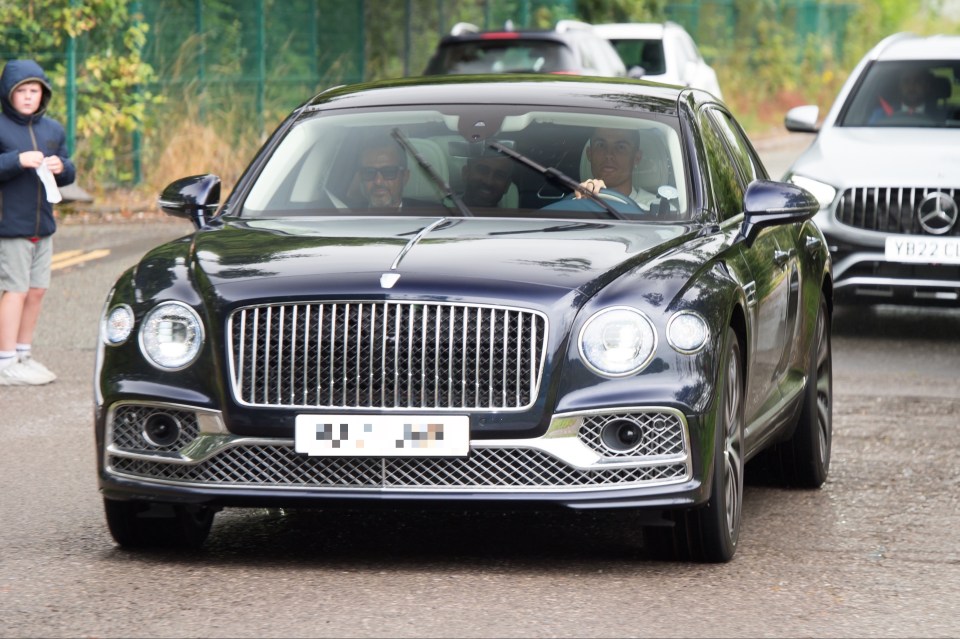 Cristiano Ronaldo driving a Bentley.