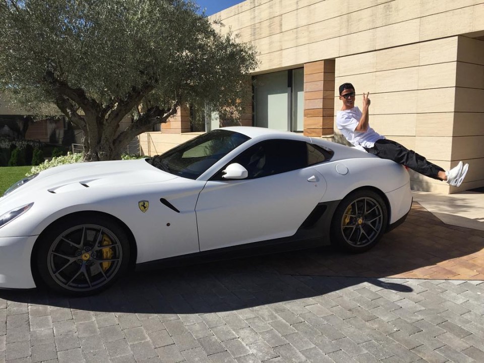Cristiano Ronaldo sitting on a white Ferrari.