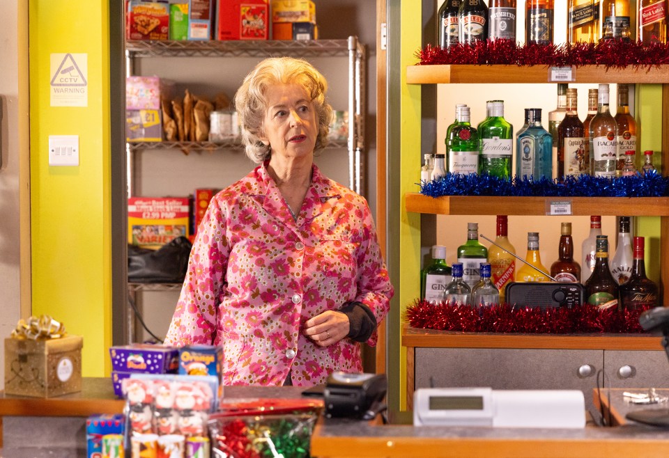 Evelyn Plummer in her shop, which has a closed sign on the door.