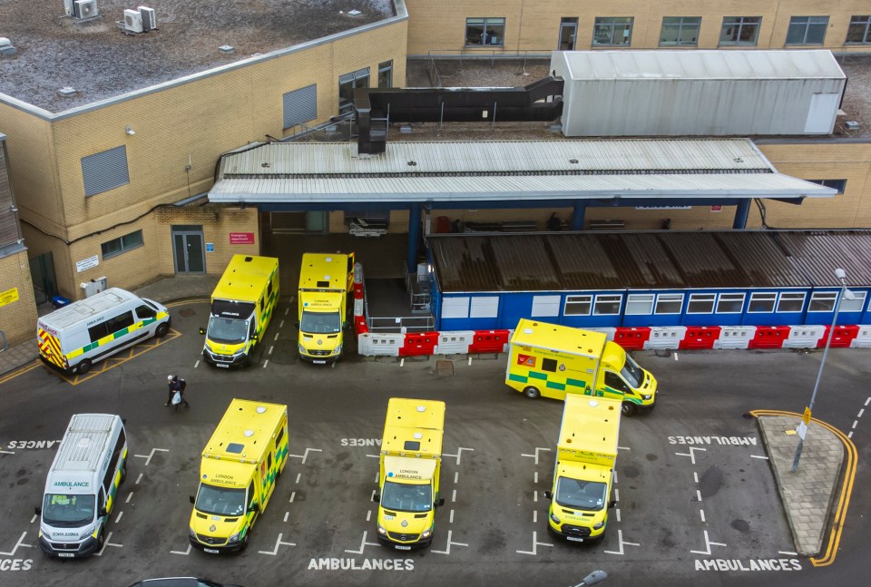 Multiple ambulances parked outside a hospital.