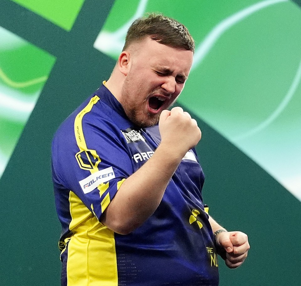 Luke Littler celebrates winning his World Darts Championship semi-final match.