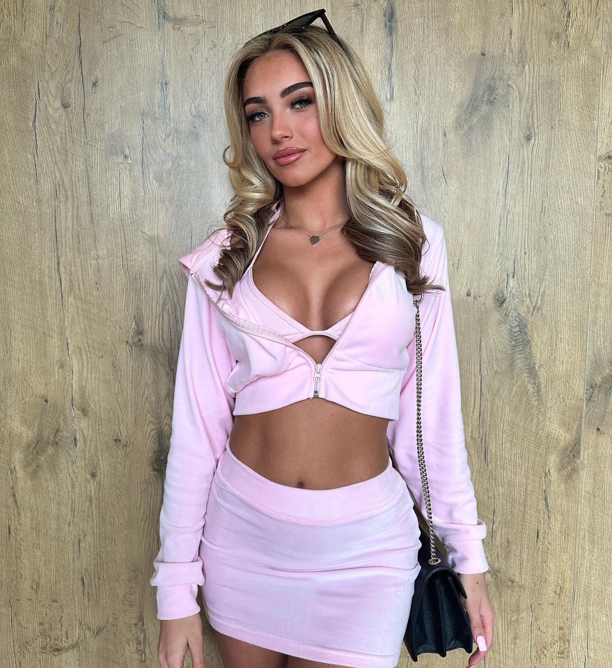 Woman in pink velour tracksuit.