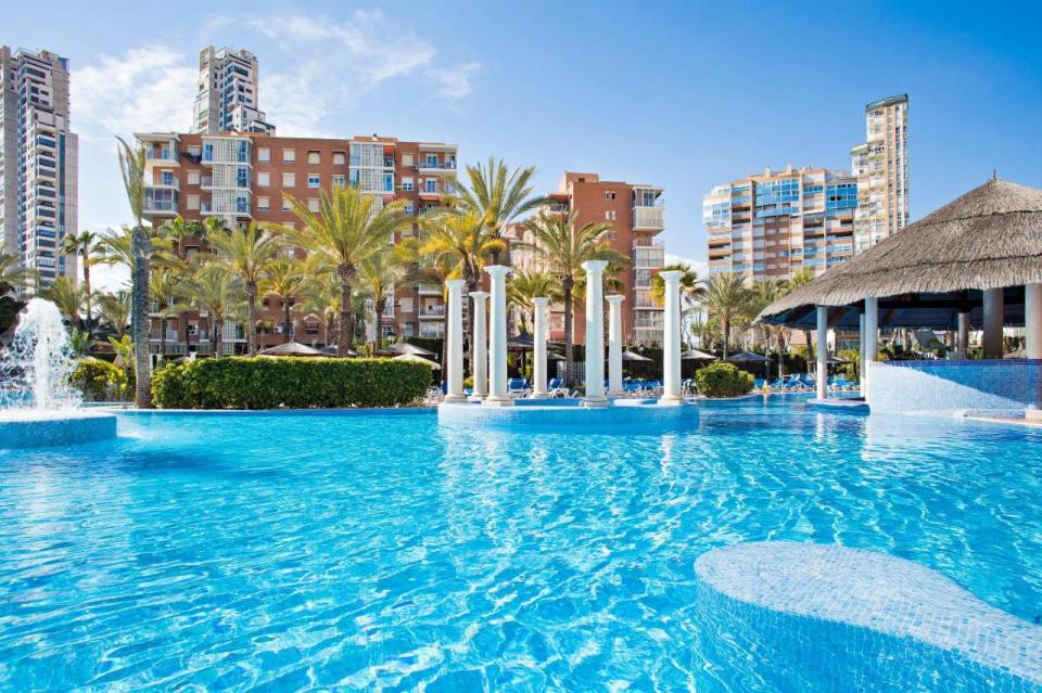 Pool with columns and swim-up bar at a resort in Benidorm, Spain.
