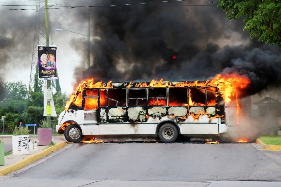 Burning bus on a road.