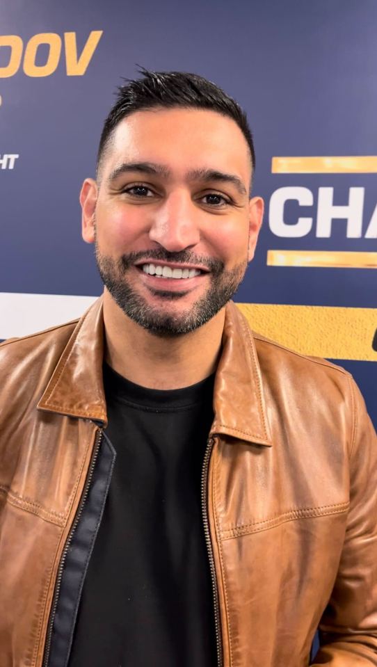 Headshot of a man in a brown leather jacket.