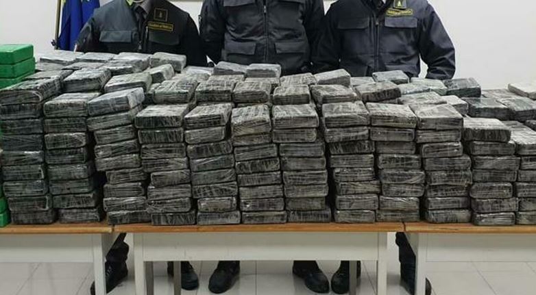 Seized drug bricks displayed during a drug bust.
