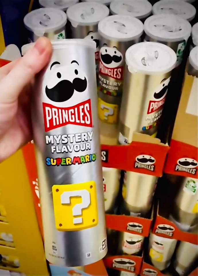 Hand holding a can of Pringles Super Mario Mystery Flavor.
