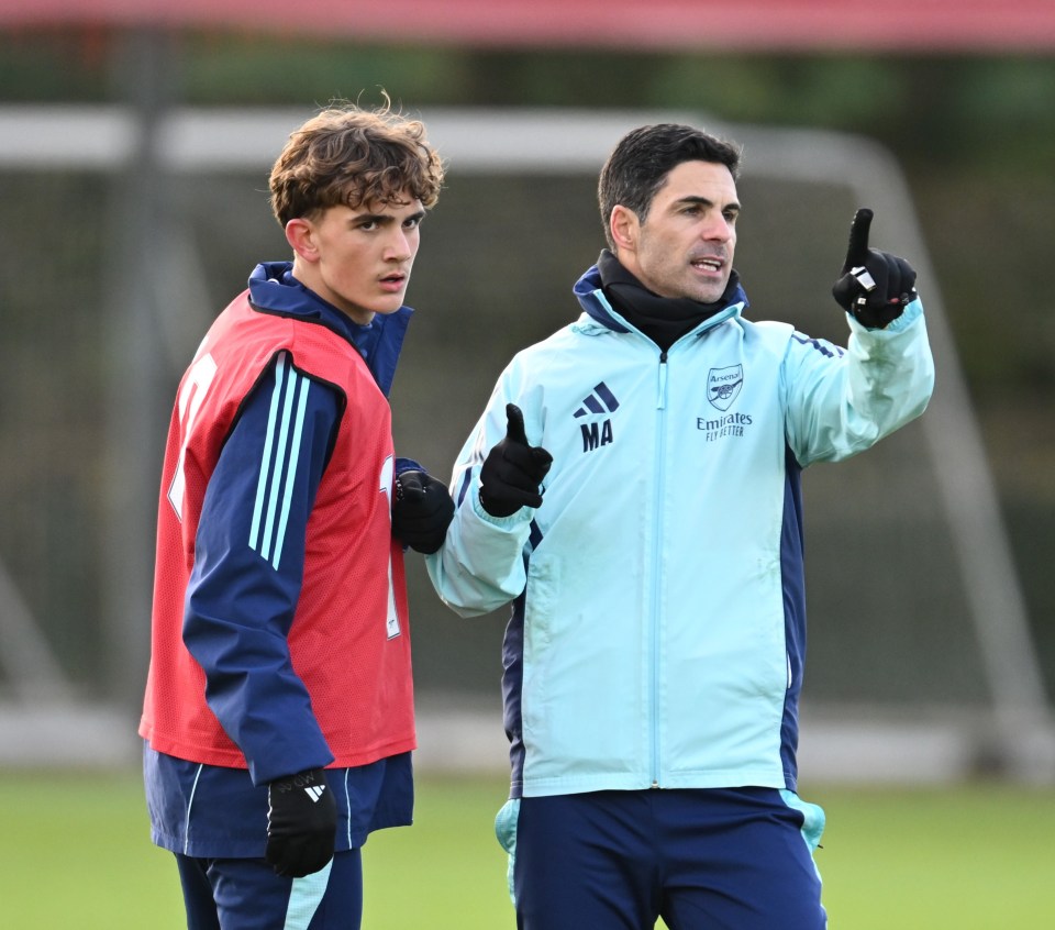 Mikel Arteta coaching a player at Arsenal training.