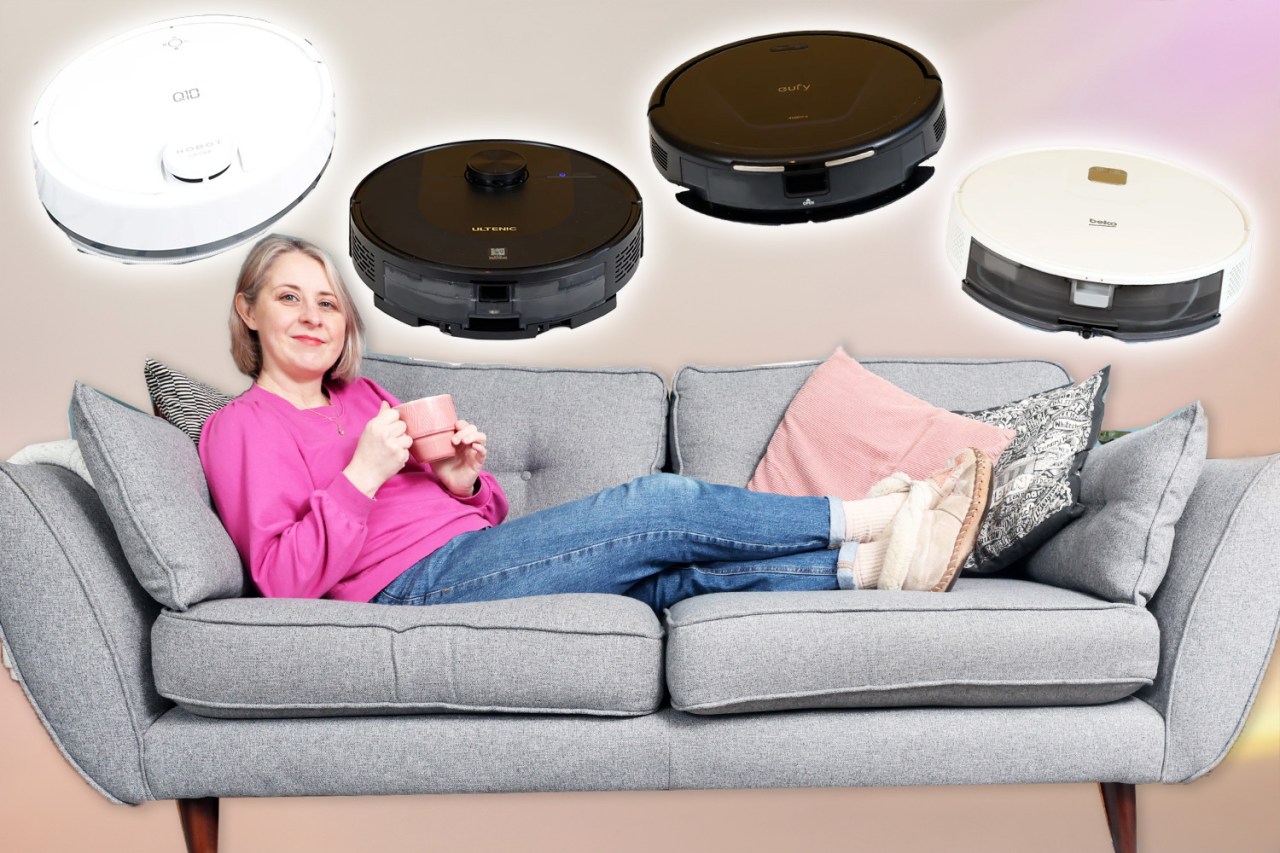 Woman relaxing on a sofa with four robot vacuum cleaners displayed above.