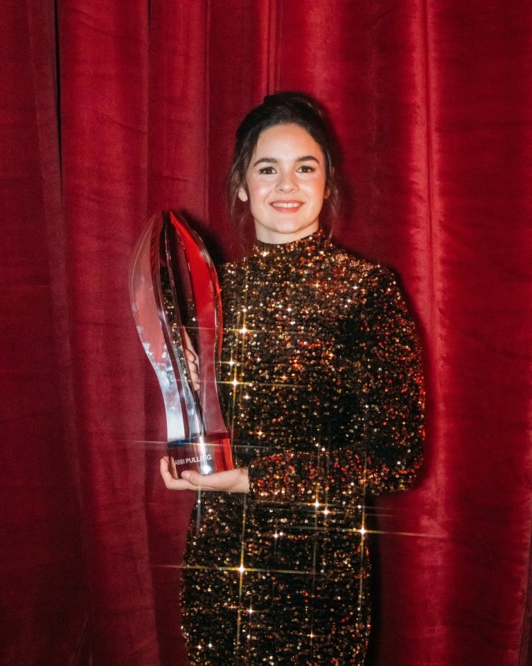 Abbi Pulling holding an award.