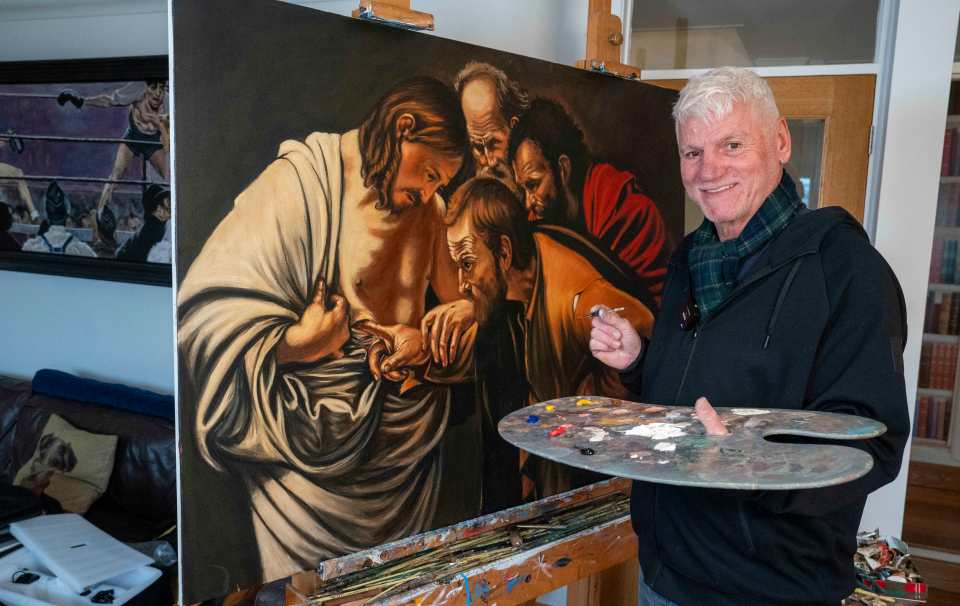 A man stands beside his painting, a copy of Caravaggio's "The Incredulity of Saint Thomas," holding a paint palette.