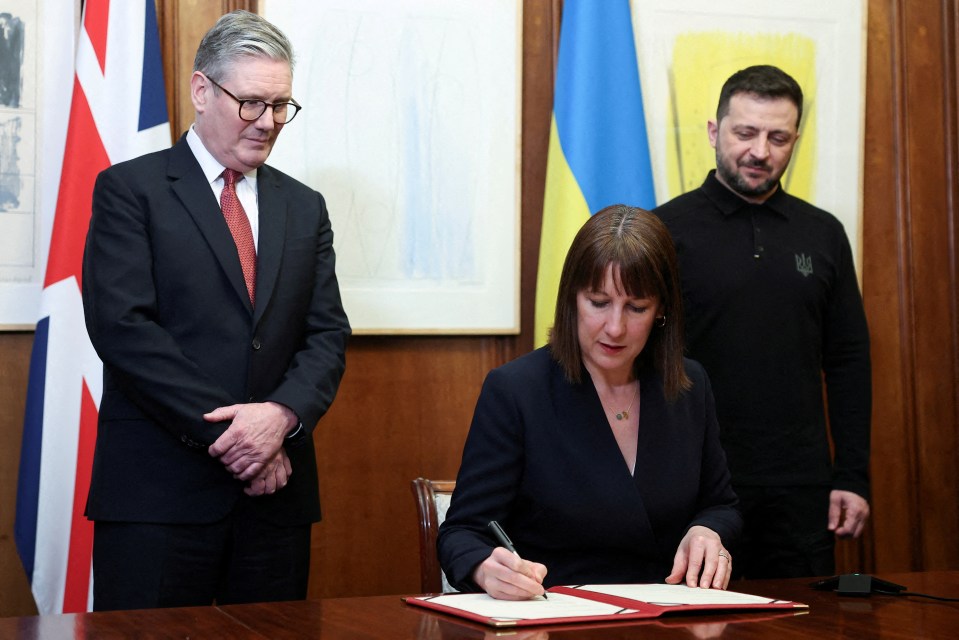 Rachel Reeves, Britain's Chancellor of the Exchequer, signing a document.