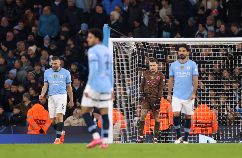 Manchester City goalkeeper Ederson looks dejected after conceding a goal.