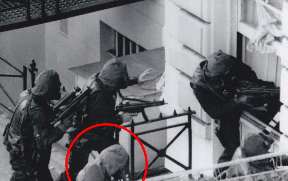 Black and white photo of armed soldiers during a raid.