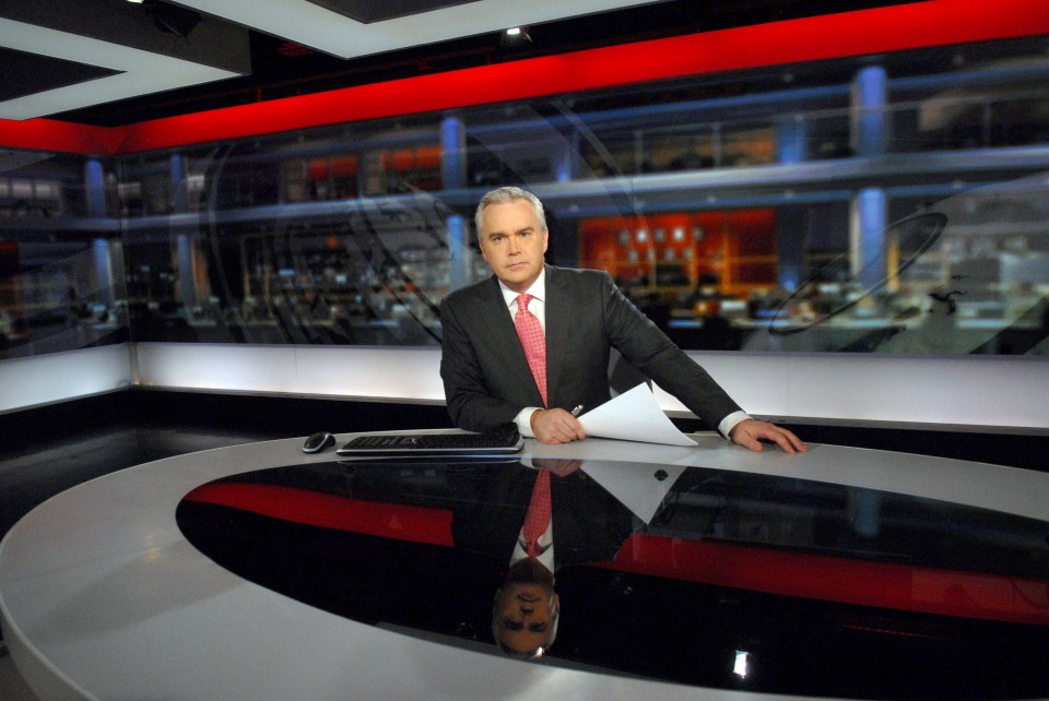 News anchor at a news desk.