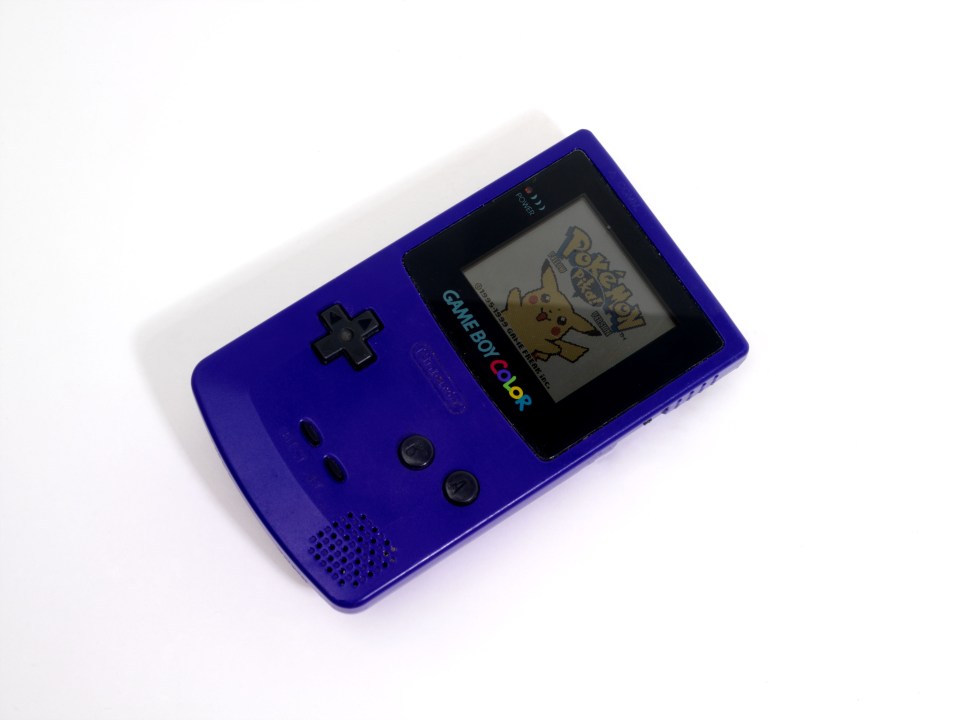 Purple Game Boy Color playing Pokémon Yellow.