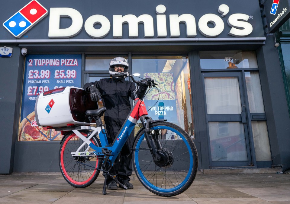 Domino's pizza delivery driver with pothole-proof e-bike.
